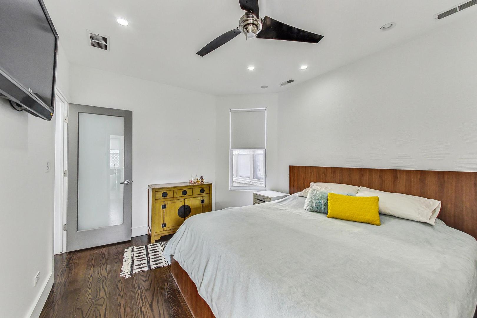 2445 West Rice Street Chicago, IL 60622 - Photo 20 of 46 a bedroom with a bed and a dresser with wooden floor