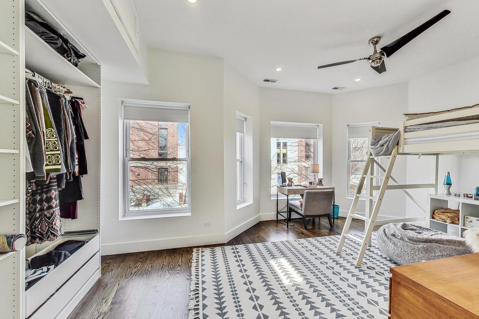 2445 West Rice Street Chicago, IL 60622 - Photo 25 of 46 a bedroom with furniture and a window