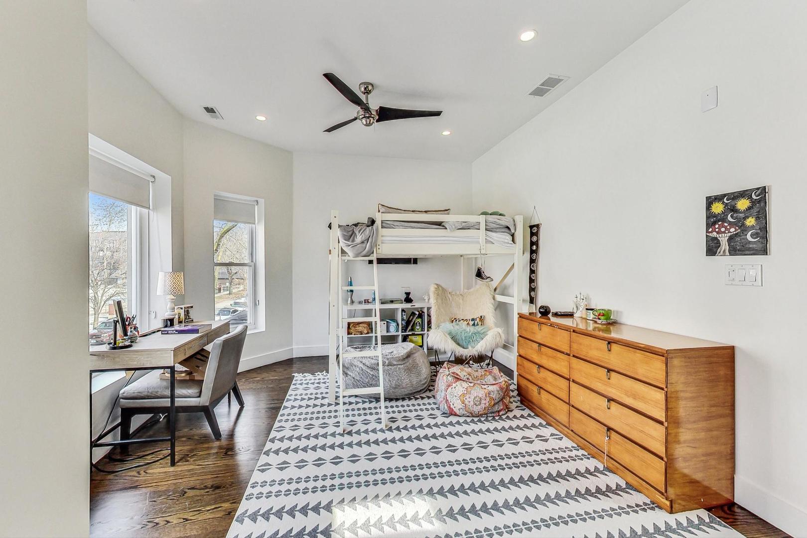 2445 West Rice Street Chicago, IL 60622 - Photo 26 of 46 a bedroom with furniture and a large window