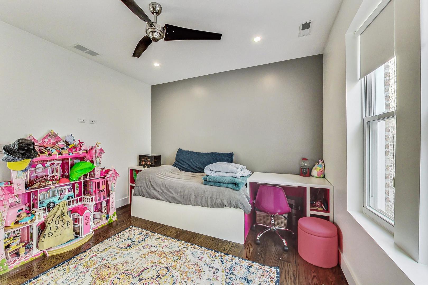 2445 West Rice Street Chicago, IL 60622 - Photo 29 of 46 a bedroom with furniture and a wooden floor