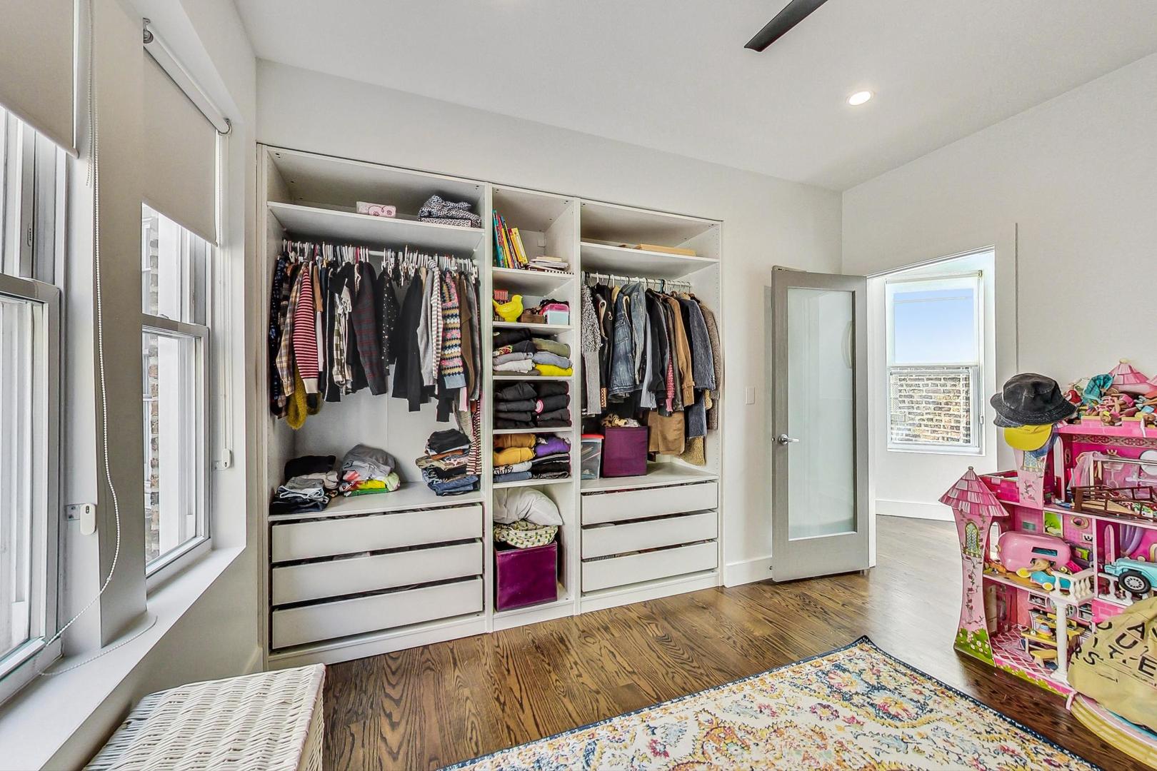 2445 West Rice Street Chicago, IL 60622 - Photo 30 of 46 a view of walk in closet with clothes and shoes
