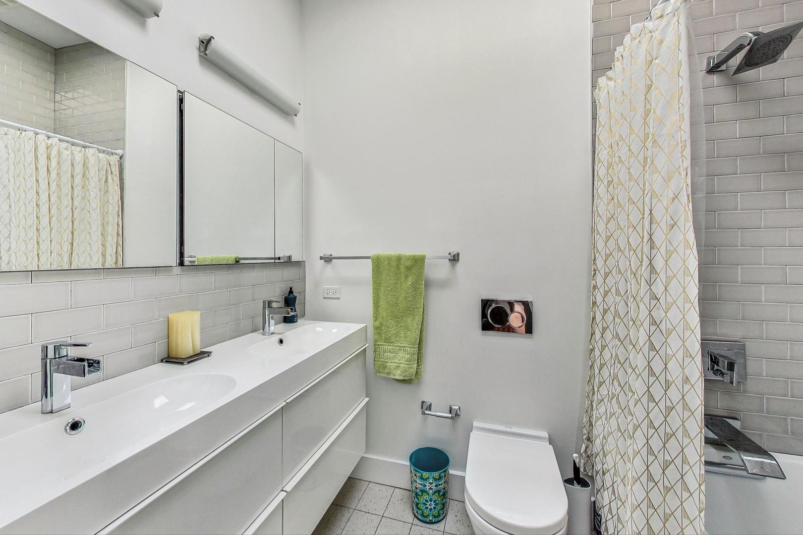 2445 West Rice Street Chicago, IL 60622 - Photo 31 of 46 a bathroom with a sink a toilet and shower