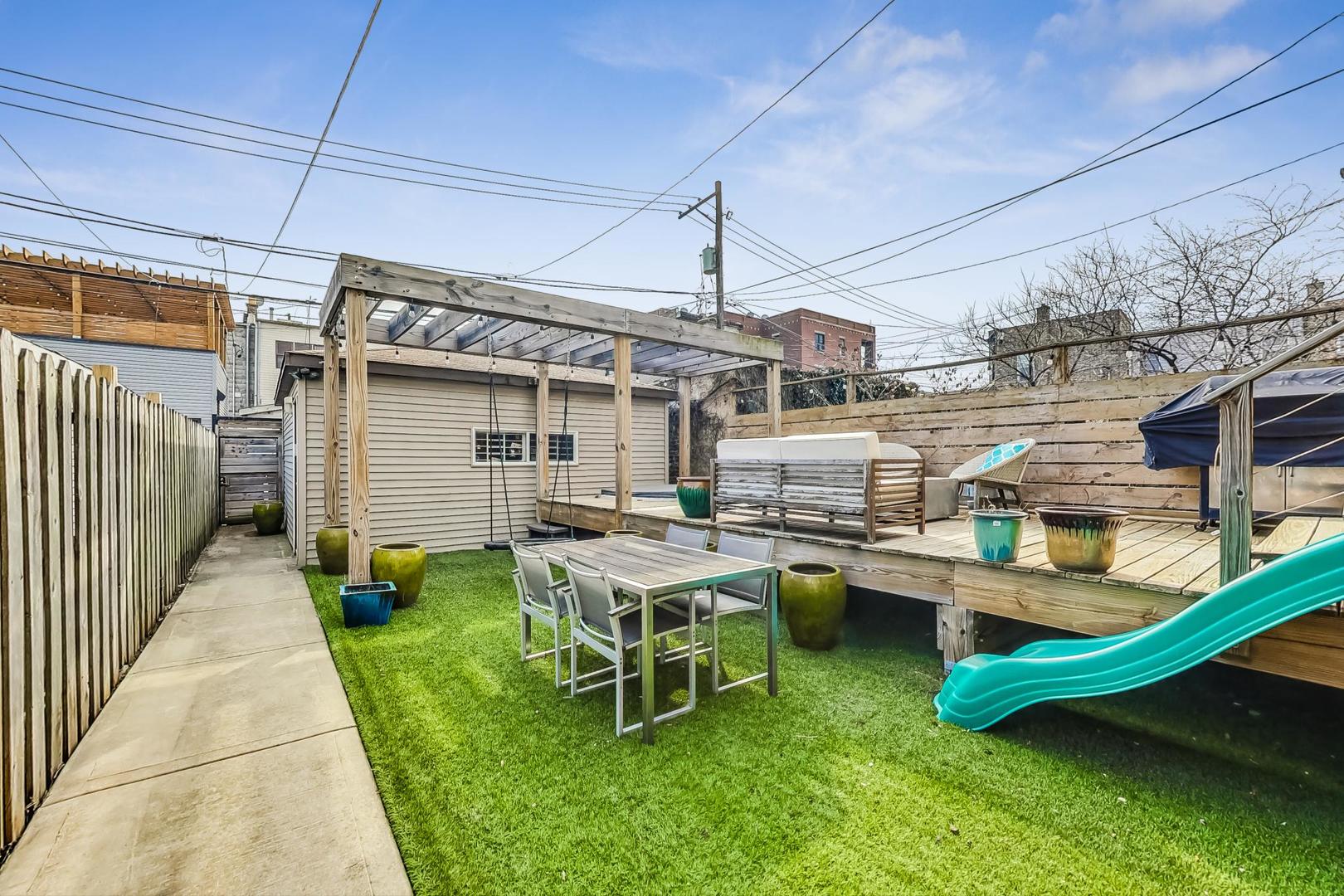 2445 West Rice Street Chicago, IL 60622 - Photo 39 of 46 a backyard of a house with yard and outdoor seating