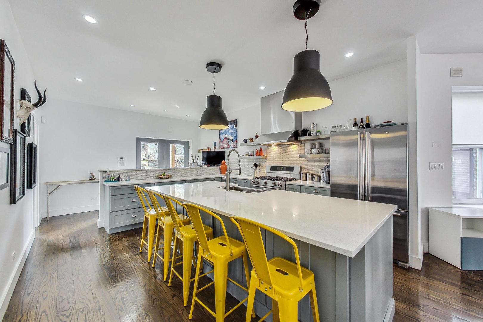 2445 West Rice Street Chicago, IL 60622 - Photo 10 of 46 a kitchen with stainless steel appliances granite countertop a sink a stove and refrigerator