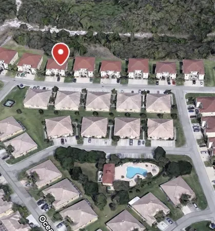 an aerial view of a red and white house