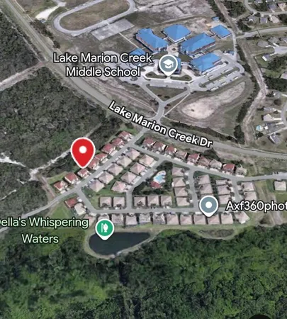 an aerial view of a house with yard swimming pool and outdoor seating