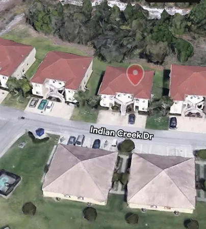 a view of a house with a yard and sitting area