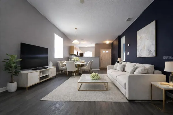 a living room with furniture and a flat screen tv