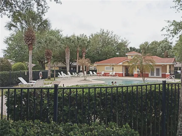 a front view of a multi story residential apartment building with outdoor space and trees
