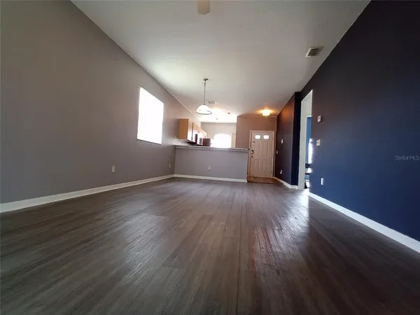 a view of a room with window and wooden floor