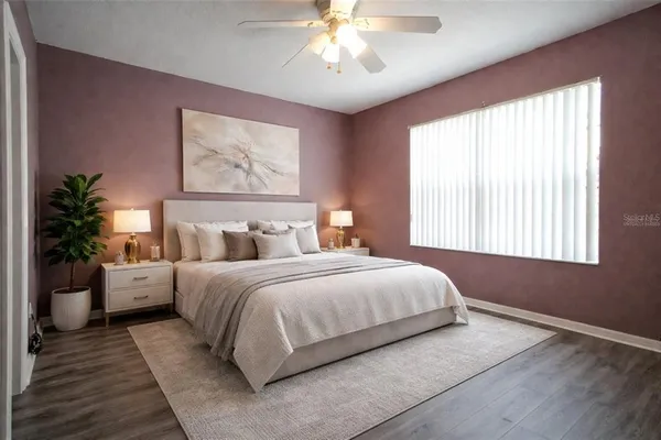 a bedroom with a large bed and a window