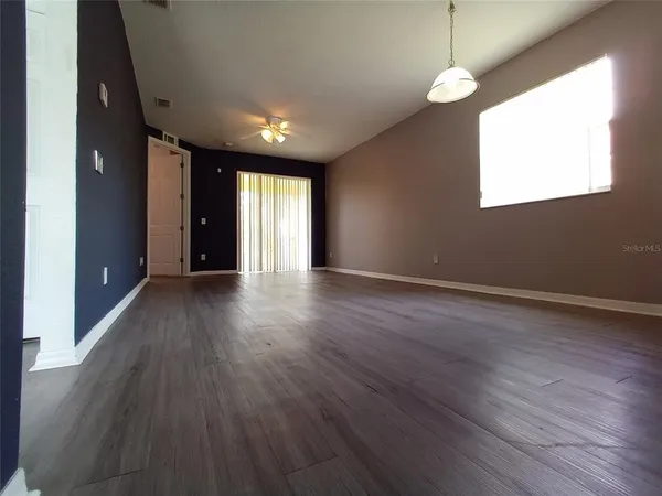 a kitchen with granite countertop a refrigerator stove and sink