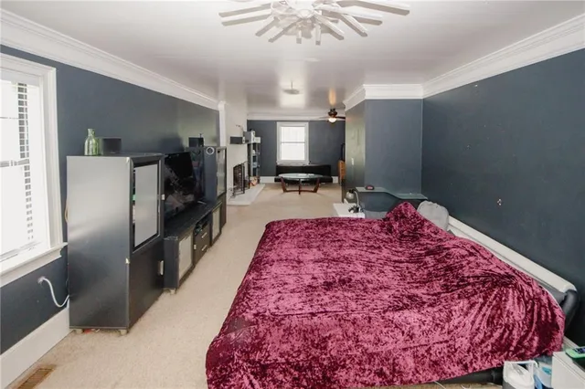 a bed in a kitchen next to a window