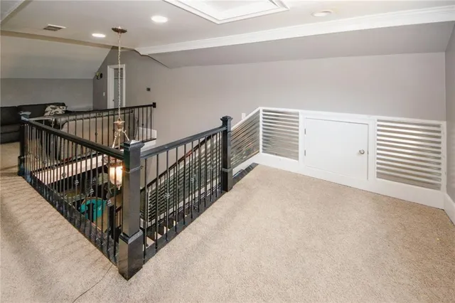 a view of staircase with lots of frames on wall