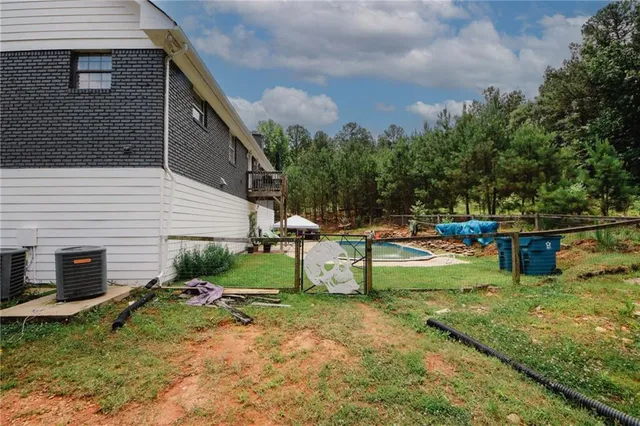 a view of a backyard with swimming pool