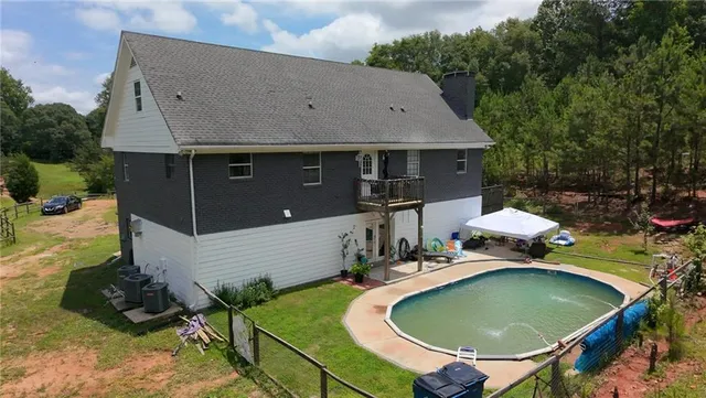 an aerial view of a house with outdoor space patio and furniture