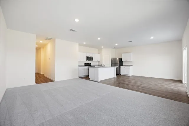 a view of a kitchen with a sink and a refrigerator
