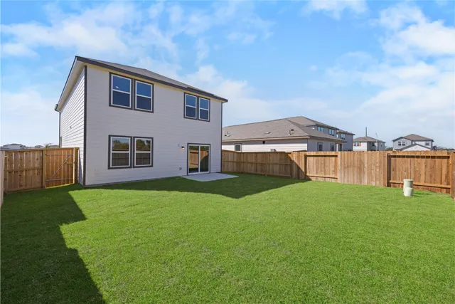 a view of a house with backyard and a garden
