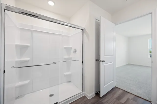 a bathroom with a glass shower door