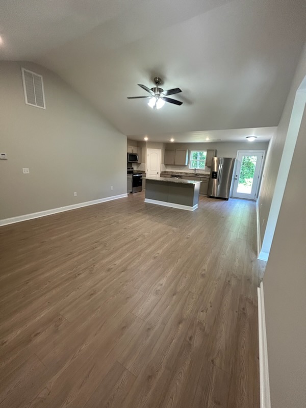 708 Hampton Street Iva, SC 29655 - Photo 5 of 14 This expansive open-concept area seamlessly combines living and kitchen spaces, perfect for gatherings.