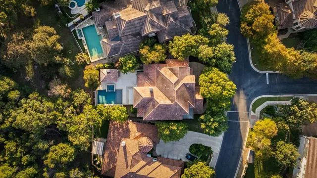 an aerial view of a house with a yard and garden