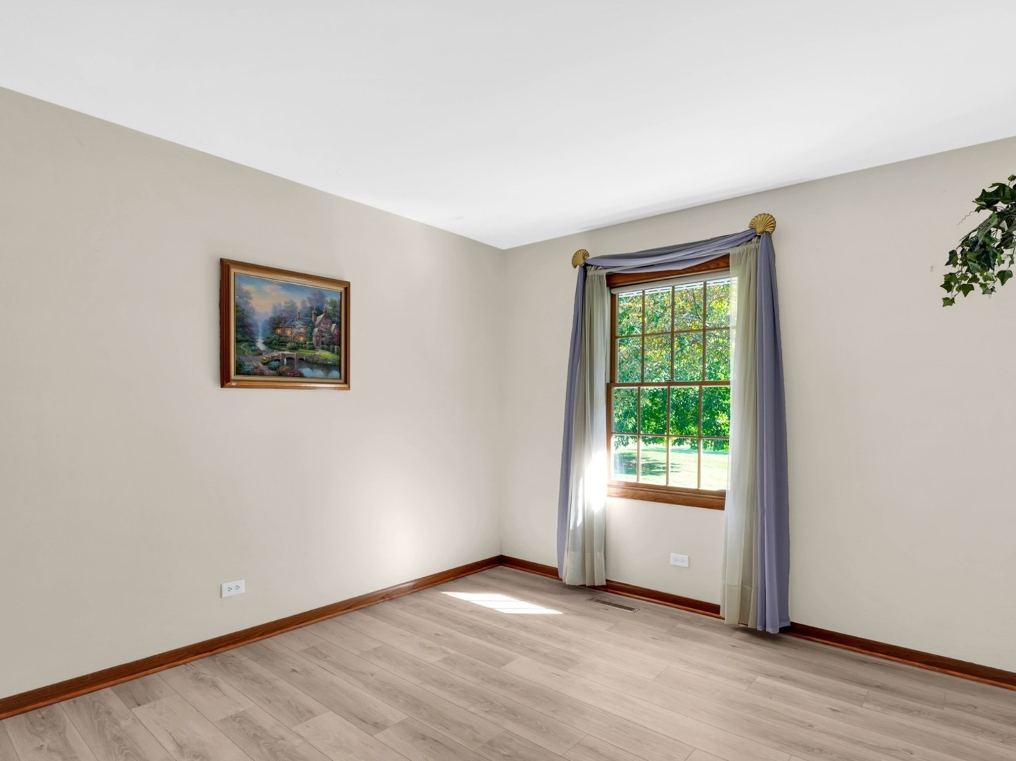 3303 Vermont Road Woodstock, IL 60098 - Photo 15 of 68 a view of an empty room with wooden floor and a window