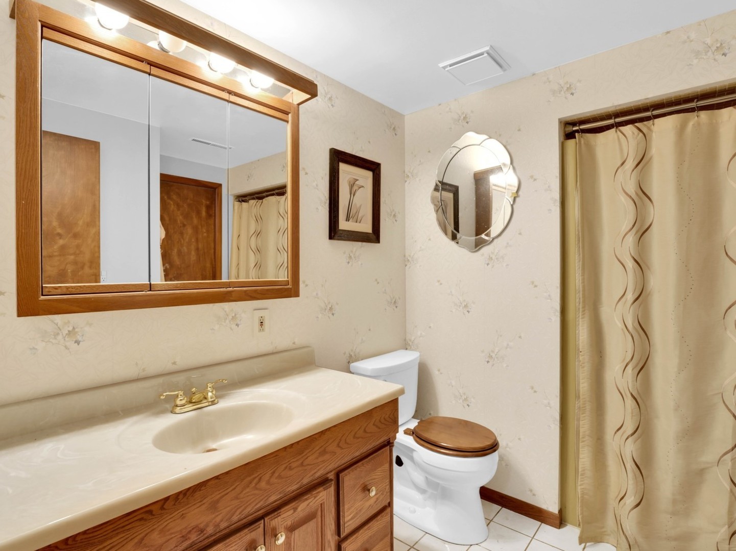 3303 Vermont Road Woodstock, IL 60098 - Photo 20 of 68 a bathroom with a granite countertop sink and a mirror