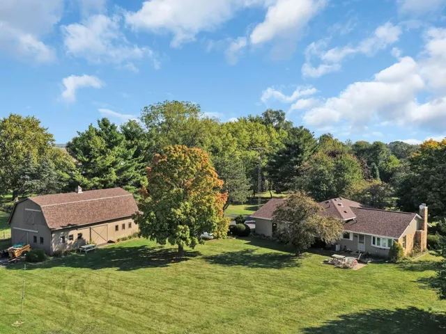 an aerial view of a houses with a yard