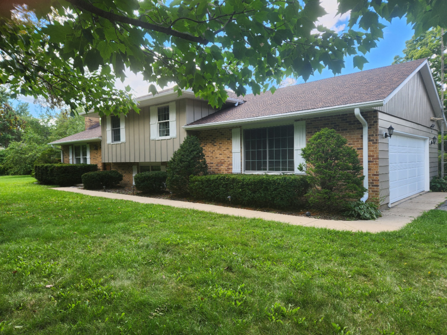 3303 Vermont Road Woodstock, IL 60098 - Photo 54 of 68 a view of a house with a yard plants and large tree