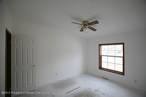 100 Ray Avenue Rifle, CO 81650 - Photo 5 of 9 wooden floor in an empty room with a window