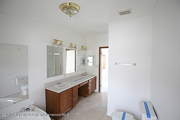 100 Ray Avenue Rifle, CO 81650 - Photo 6 of 9 a view of bathroom with mirror toilet and a sink
