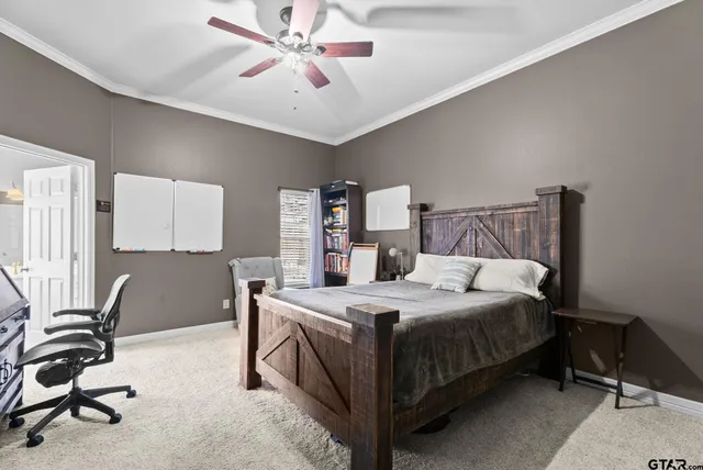 a bedroom with a bed a desk and chair