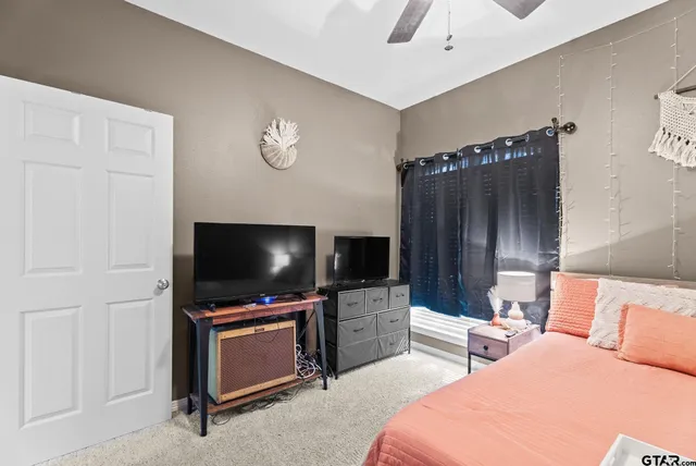 a hotel room with bed and tv