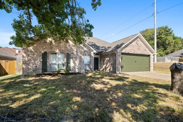 a view of a house with a yard and garage