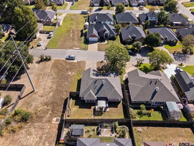 an aerial view of residential houses with outdoor space