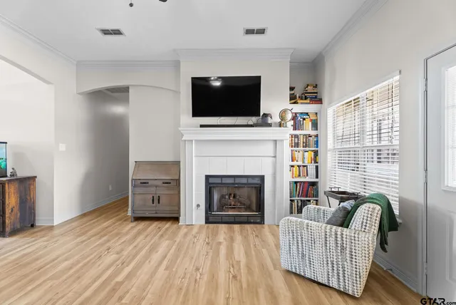 a living room with furniture fireplace and flat screen tv