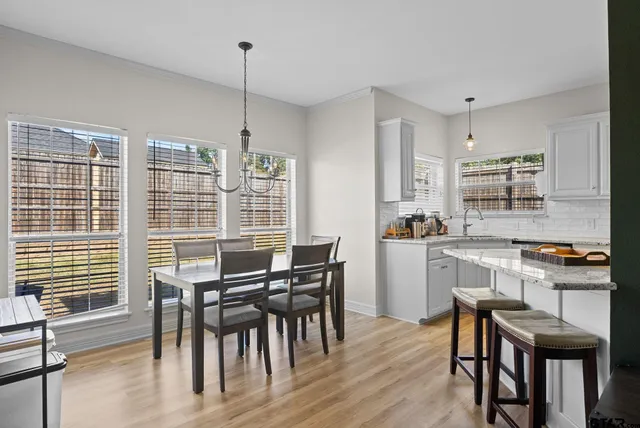 a view of a dining room with furniture and windows
