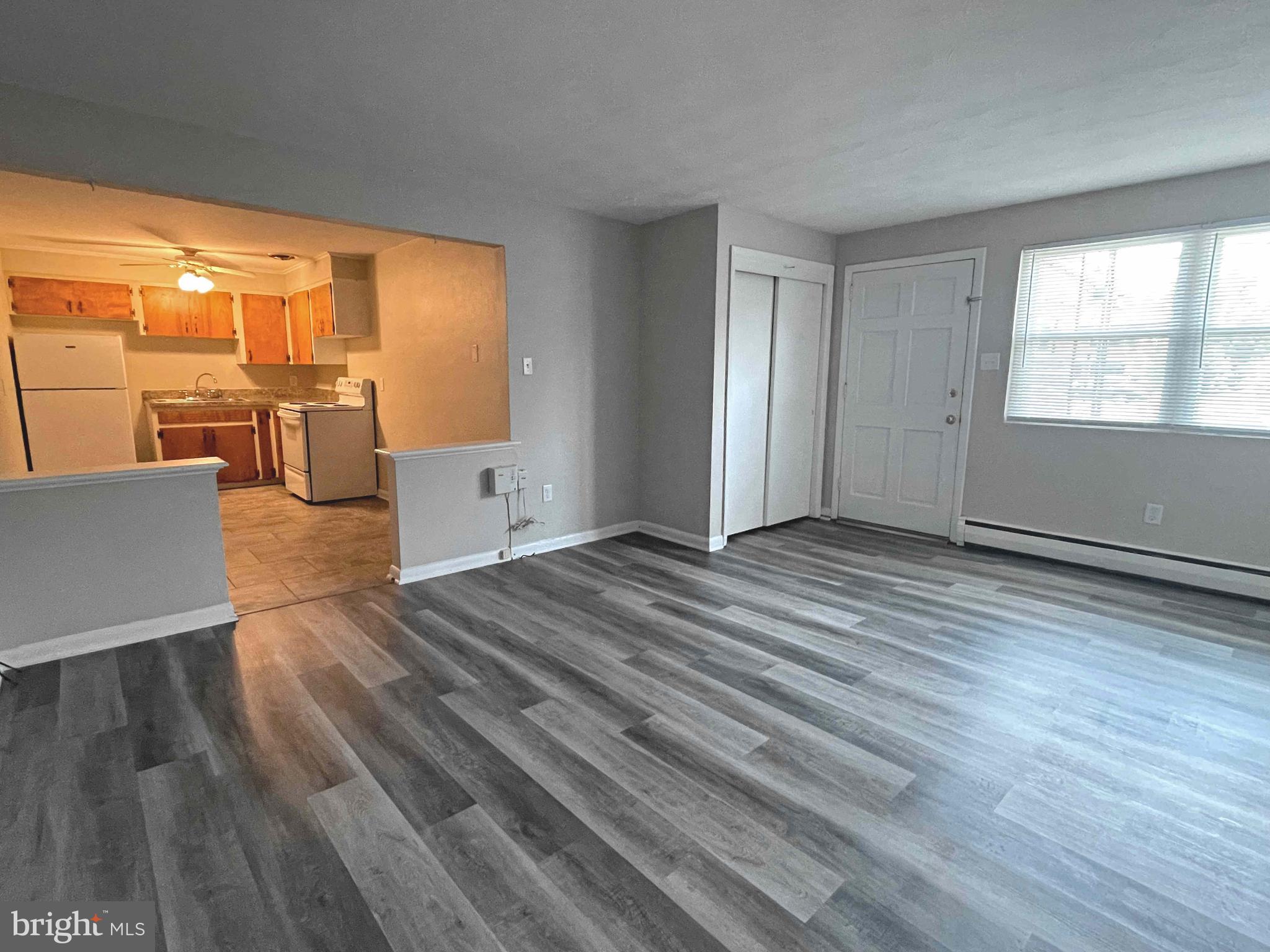 wooden floor in an empty room with a window