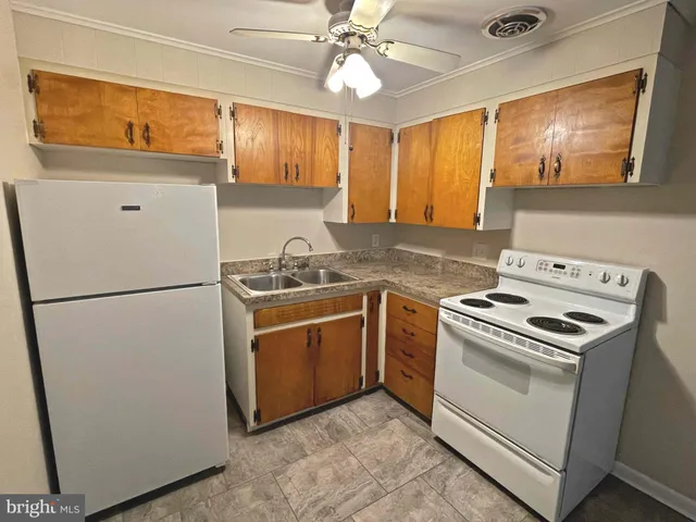 a kitchen with a stove sink and refrigerator