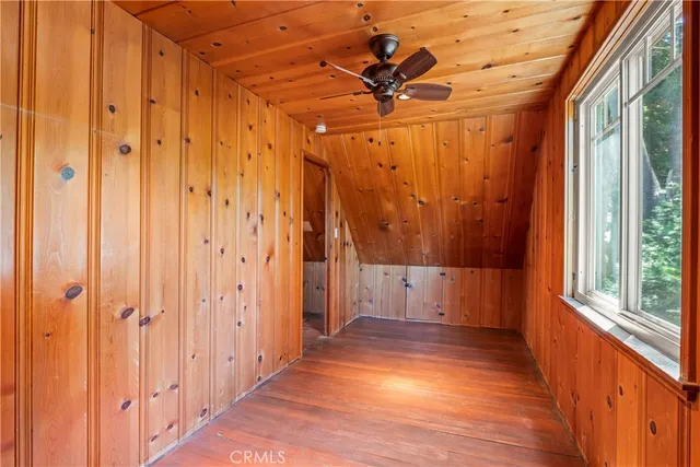 a view of a room with wooden floor and windows