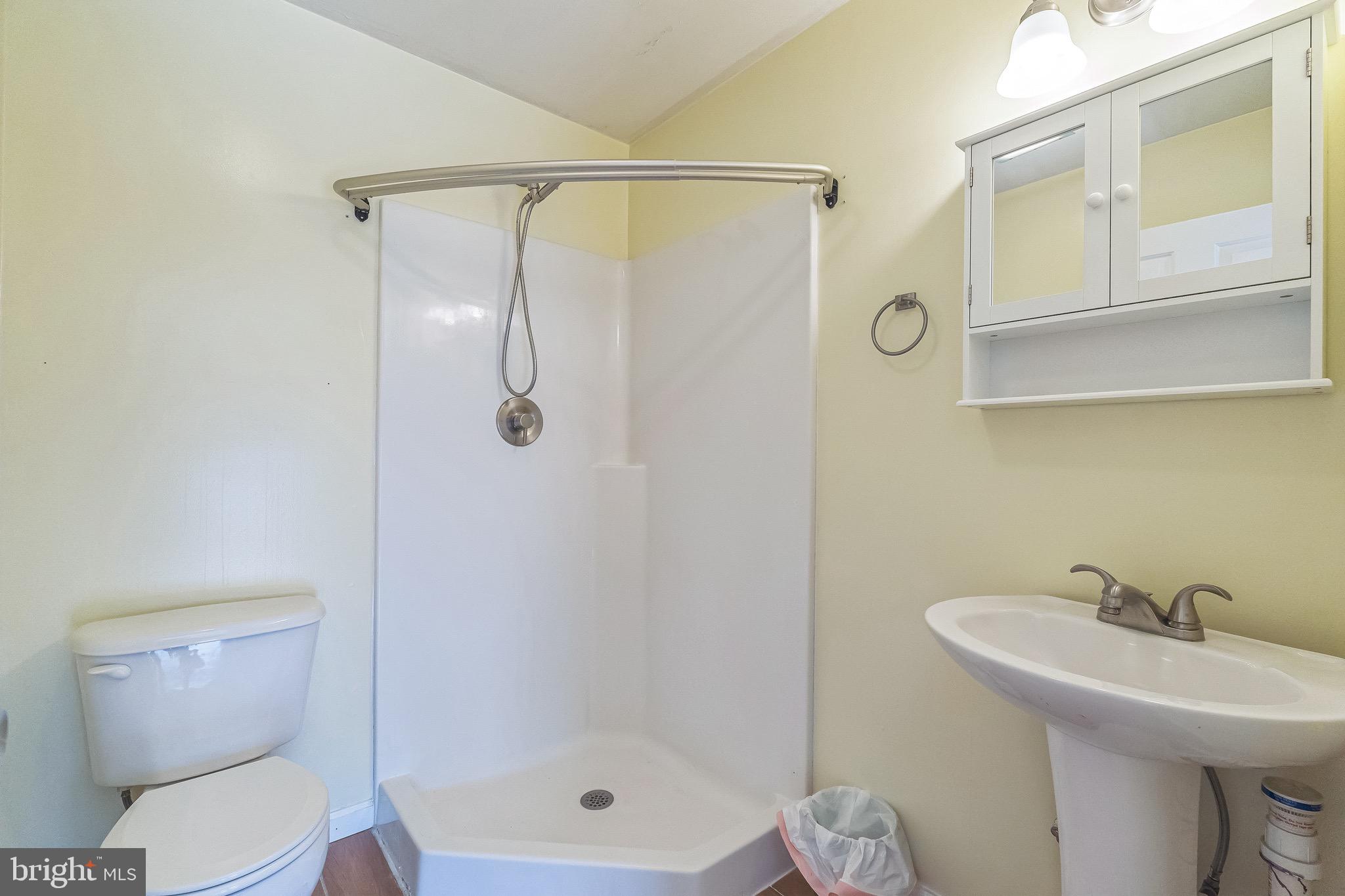 3566 Edgemont Street Philadelphia, PA 19134 - Photo 18 of 25 a bathroom with a shower a toilet and a sink