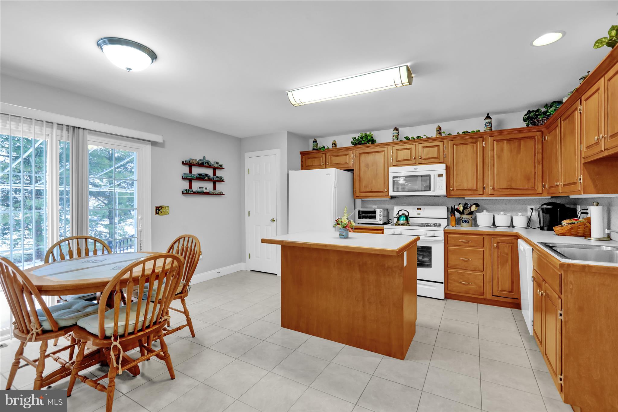 110 South Cacoosing Drive Reading, PA 19608 - Photo 11 of 32 a kitchen with stainless steel appliances a refrigerator a stove a sink dishwasher and a dining table with the kitchen view