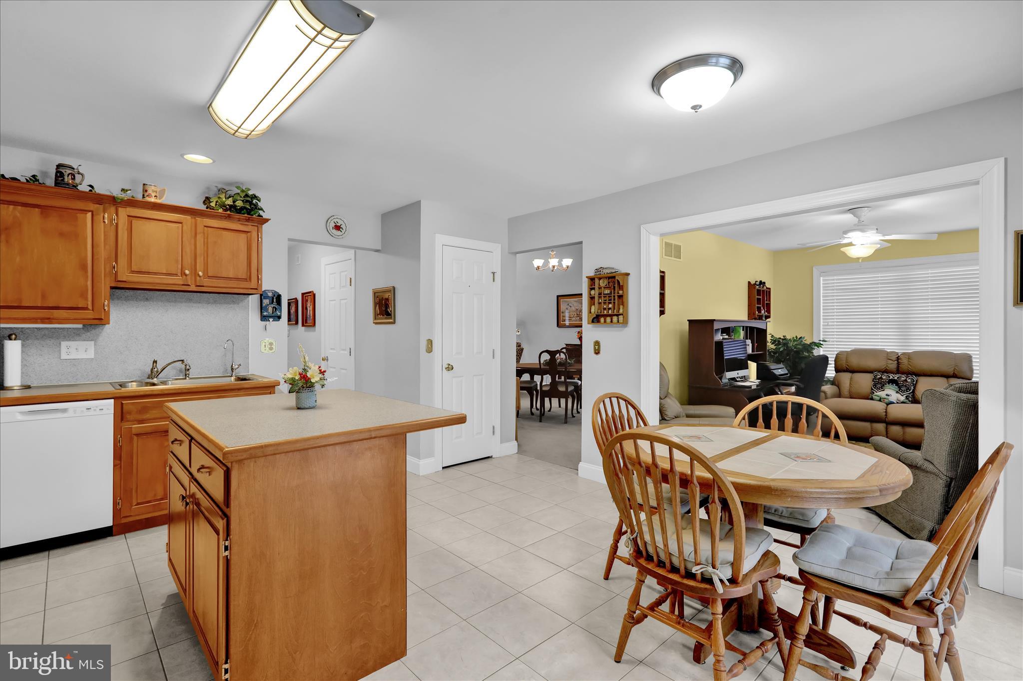 110 South Cacoosing Drive Reading, PA 19608 - Photo 14 of 32 a kitchen with a dining table chairs and white cabinets