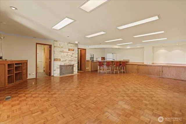 a view of empty room with furniture and large window