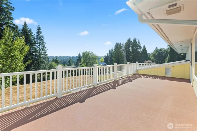 a white house that has a tree in front of it