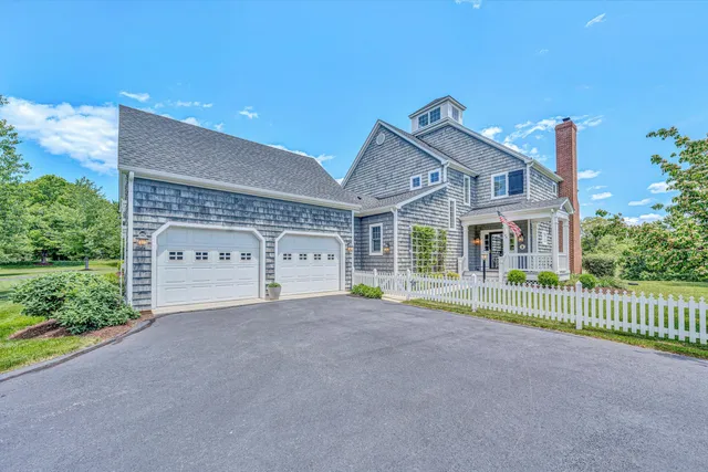 a view of a house with a yard and potted plants