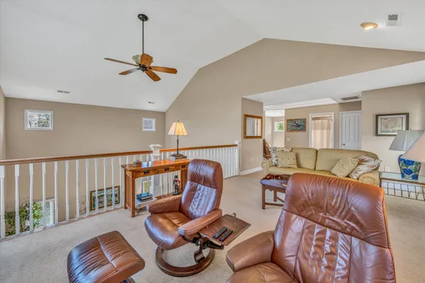a living room with furniture a rug and a window