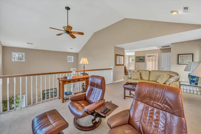 a living room with furniture a rug and a window