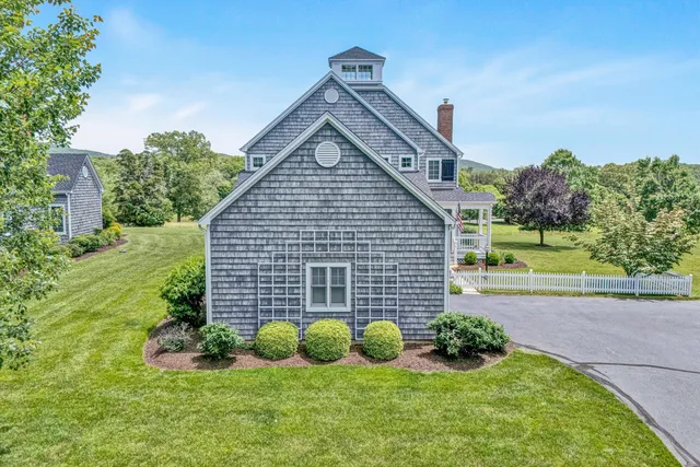 a view of a house with a yard and plants