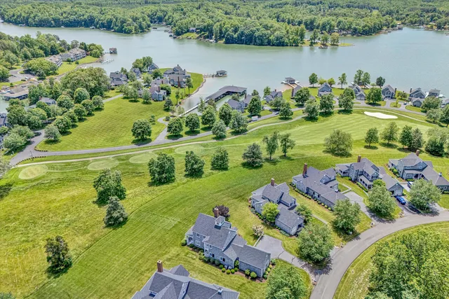 an aerial view of a house with a lake view